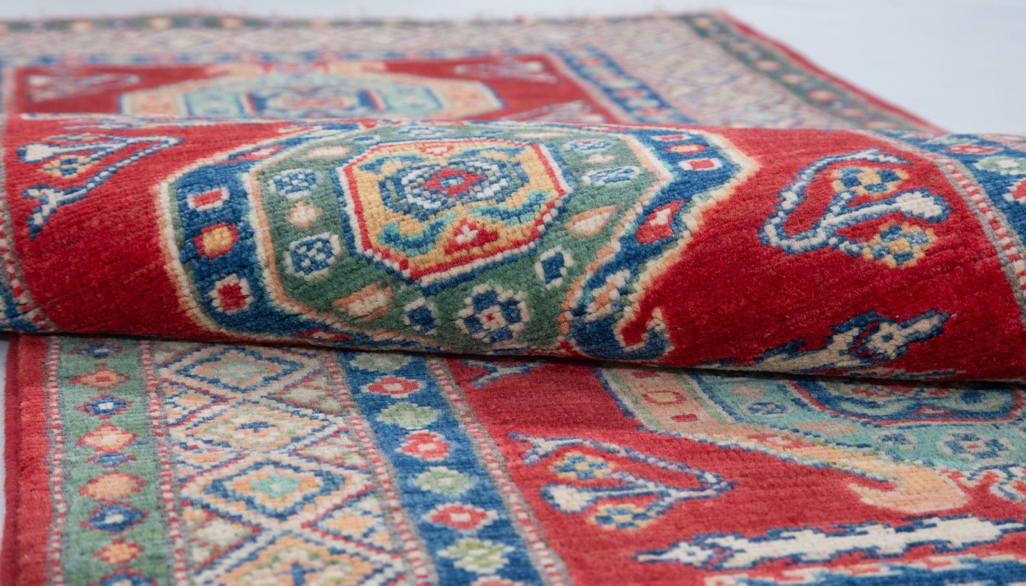 Folded edge and wool pile of red & blue Kazak-inspired wool runner 29654.