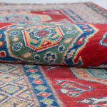 Folded edge and wool pile of red & blue Kazak-inspired wool runner 29654.