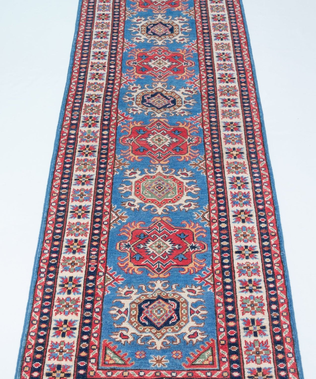 Full view from a low angle of blue & red Kazak-inspired wool runner 29653.