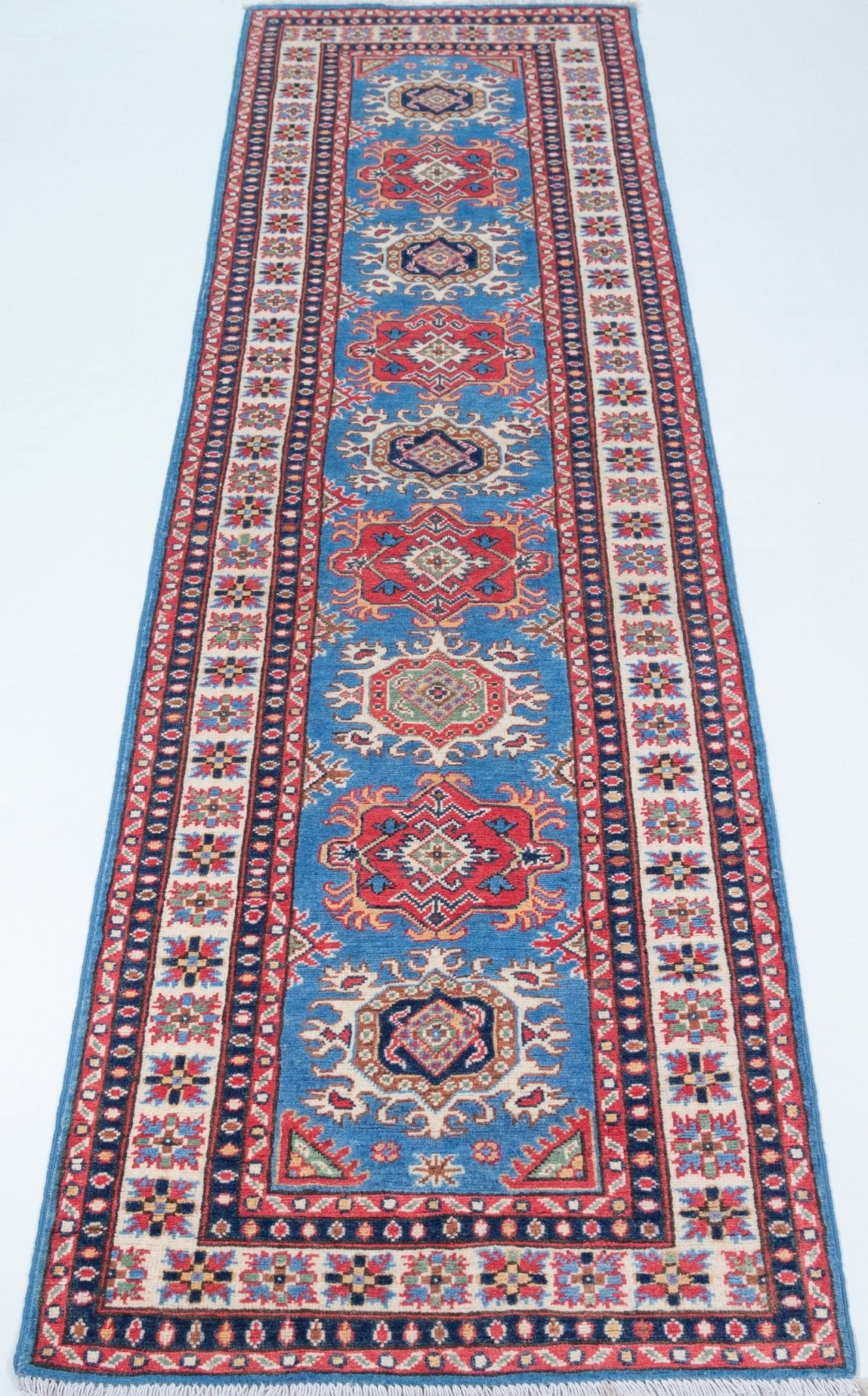 Full view from a low angle of blue & red Kazak-inspired wool runner 29653.