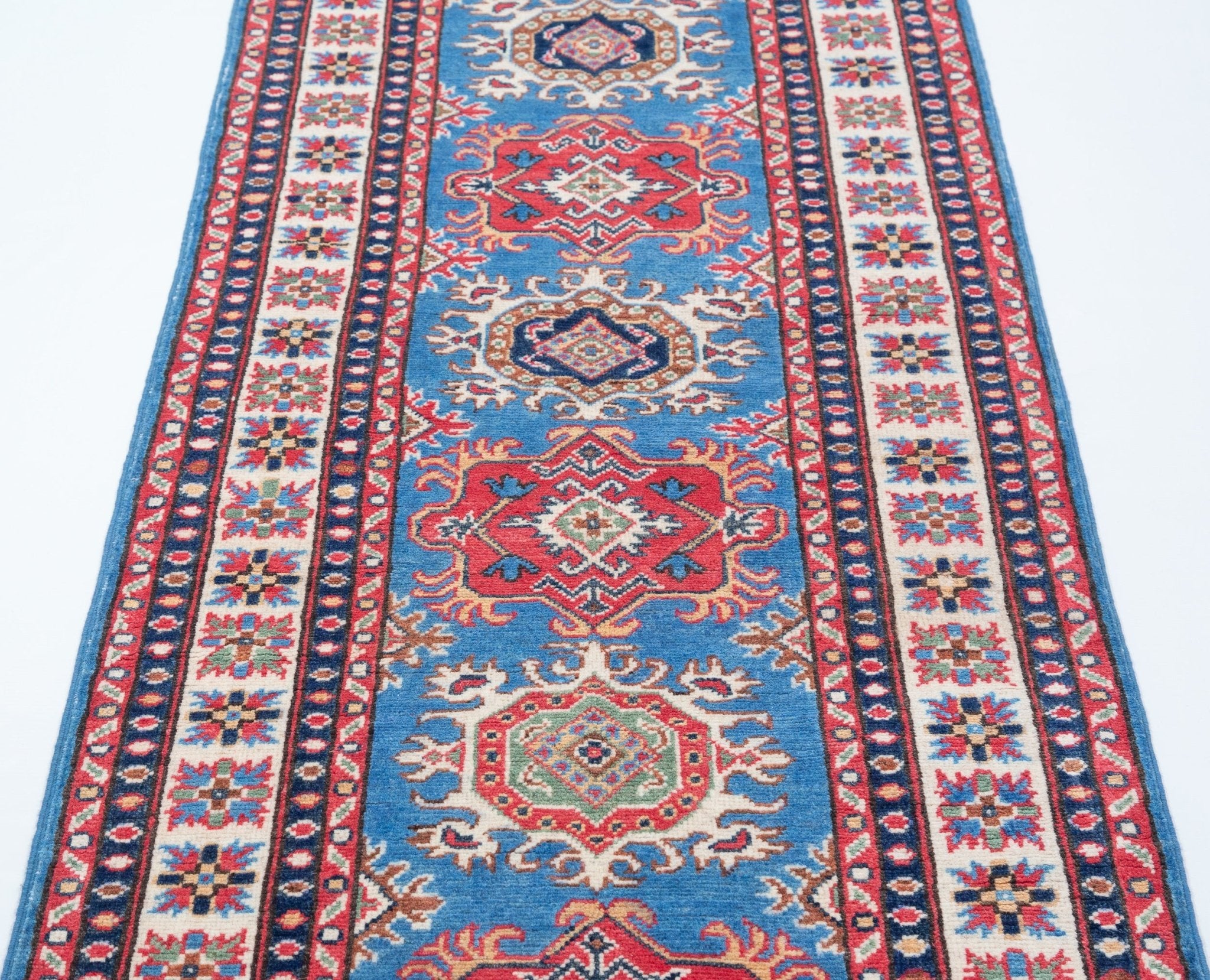 Border and edge detail of blue & red Kazak-inspired wool runner 29653.
