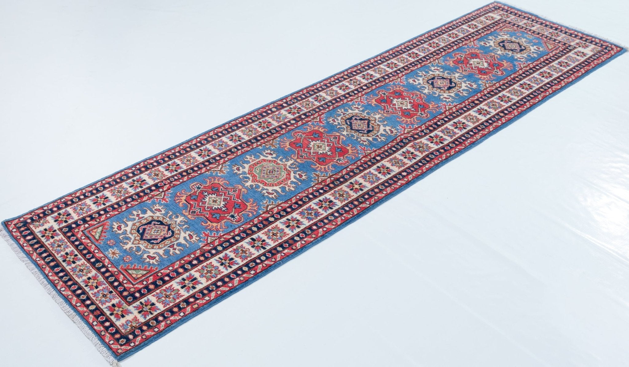 Full view at an angle of blue & red Kazak-inspired wool runner 29653.