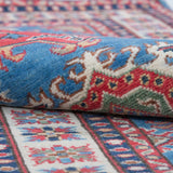 Folded edge and wool pile of blue & red Kazak-inspired wool runner 29653.