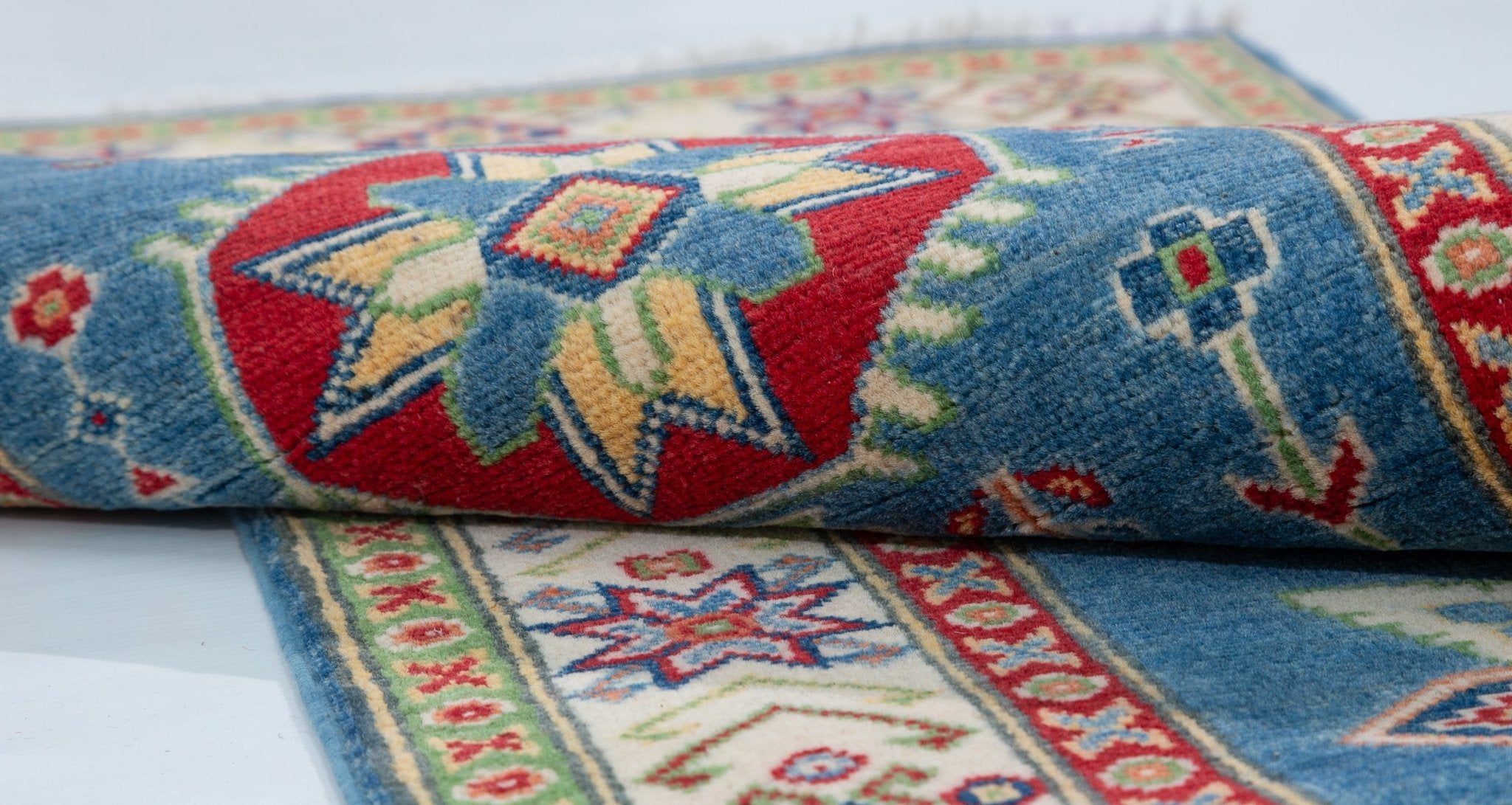 Folded edge and wool pile of blue & ivory Kazak-inspired wool runner 29655.