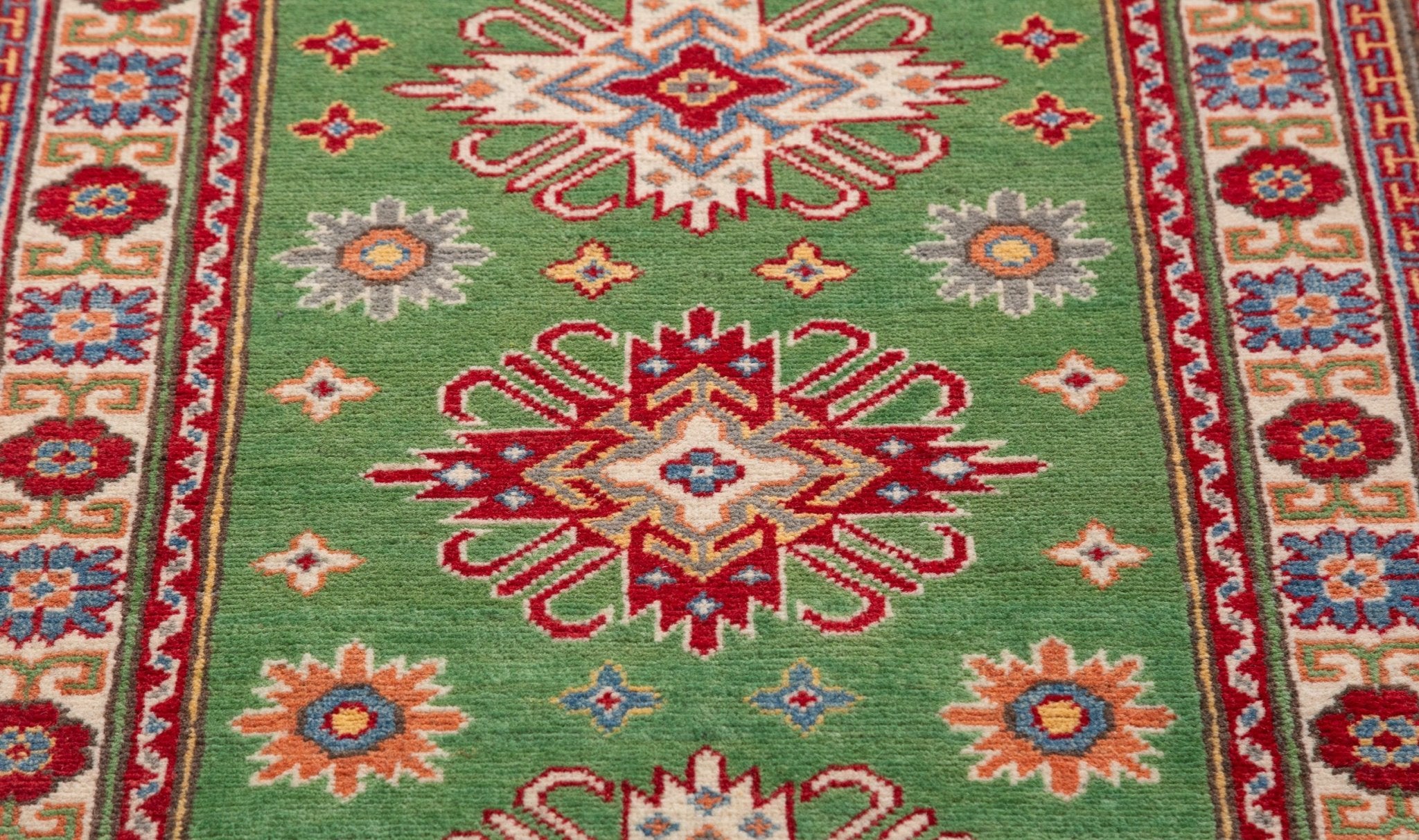 Pattern detail of green & red Kazak-inspired wool runner 29353.