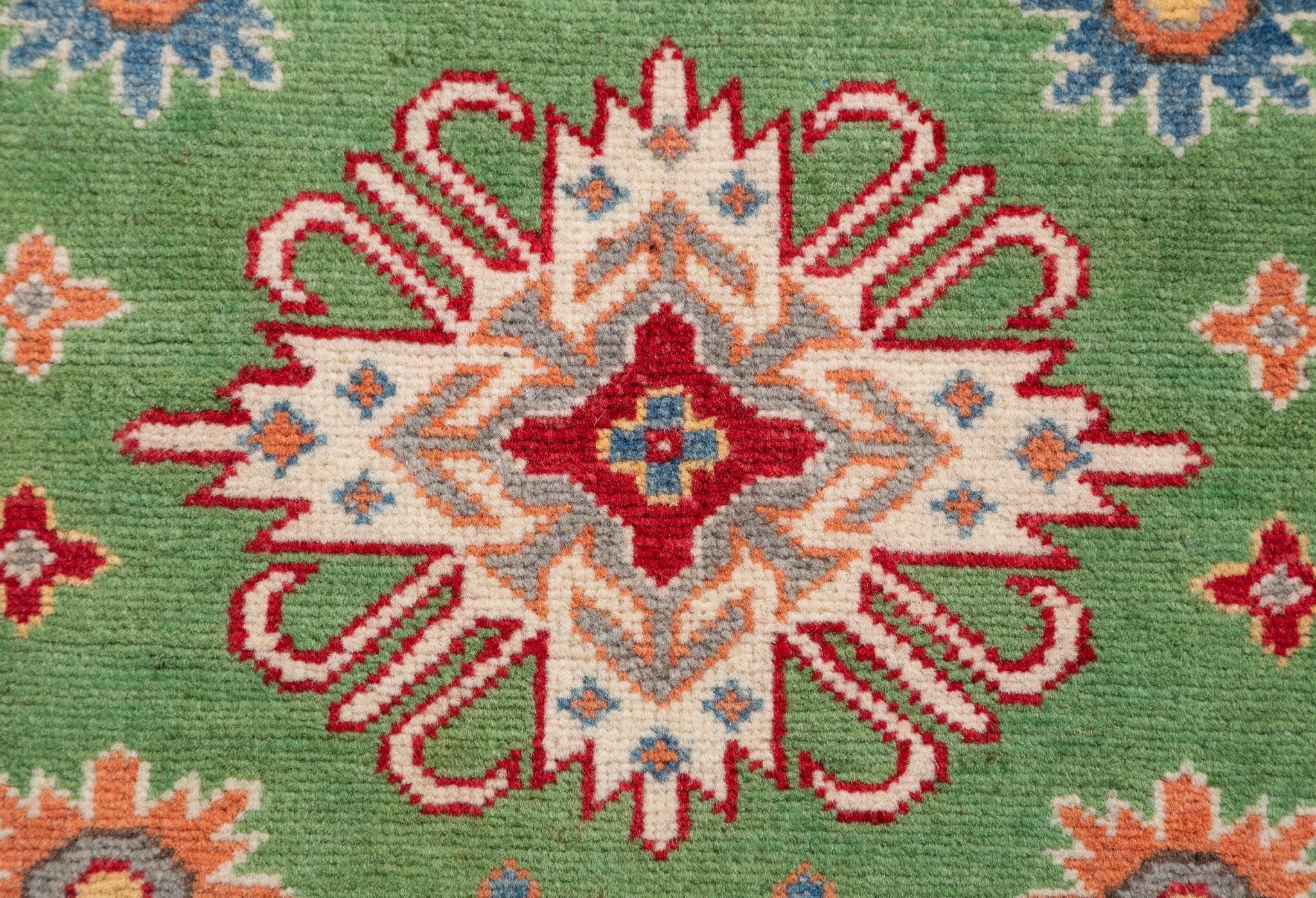 Pattern detail of green & red Kazak-inspired wool runner 29353.
