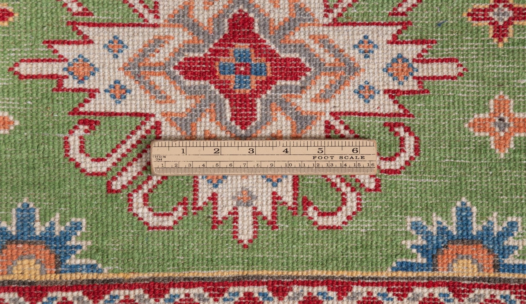 Wool pile close-up of green & red Kazak-inspired wool runner 29353.