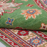 Folded edge and wool pile of green & red Kazak-inspired wool runner 29353.