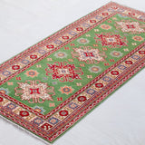 Full view at an angle of green & red Kazak-inspired wool runner 29353.