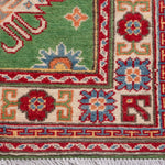 Border and edge detail of green & red Kazak-inspired wool runner 29353.