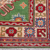 Border and edge detail of green & red Kazak-inspired wool runner 29353.