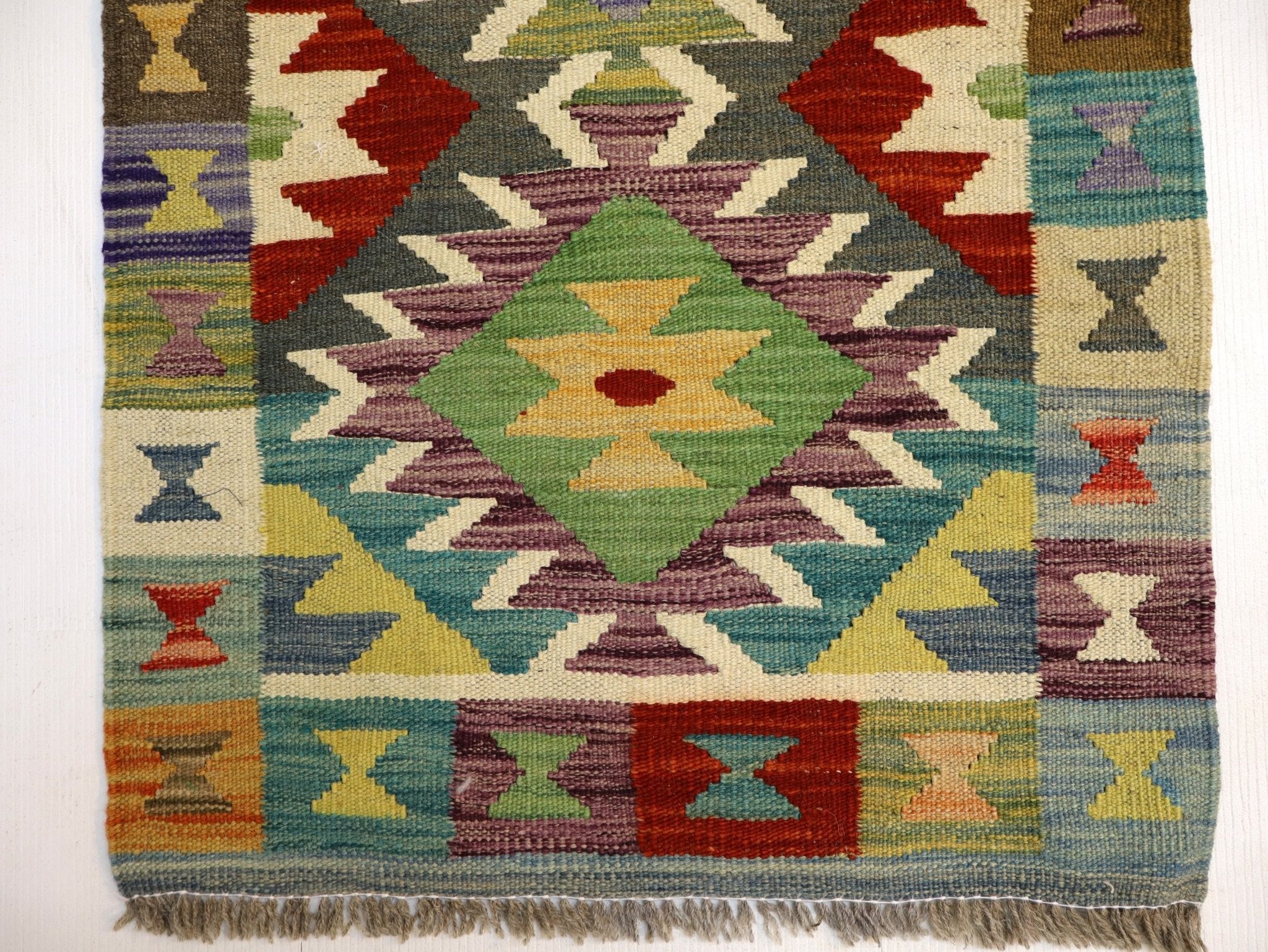 Afghan kilim rug lower section with diamond motifs and multicolor woven pattern