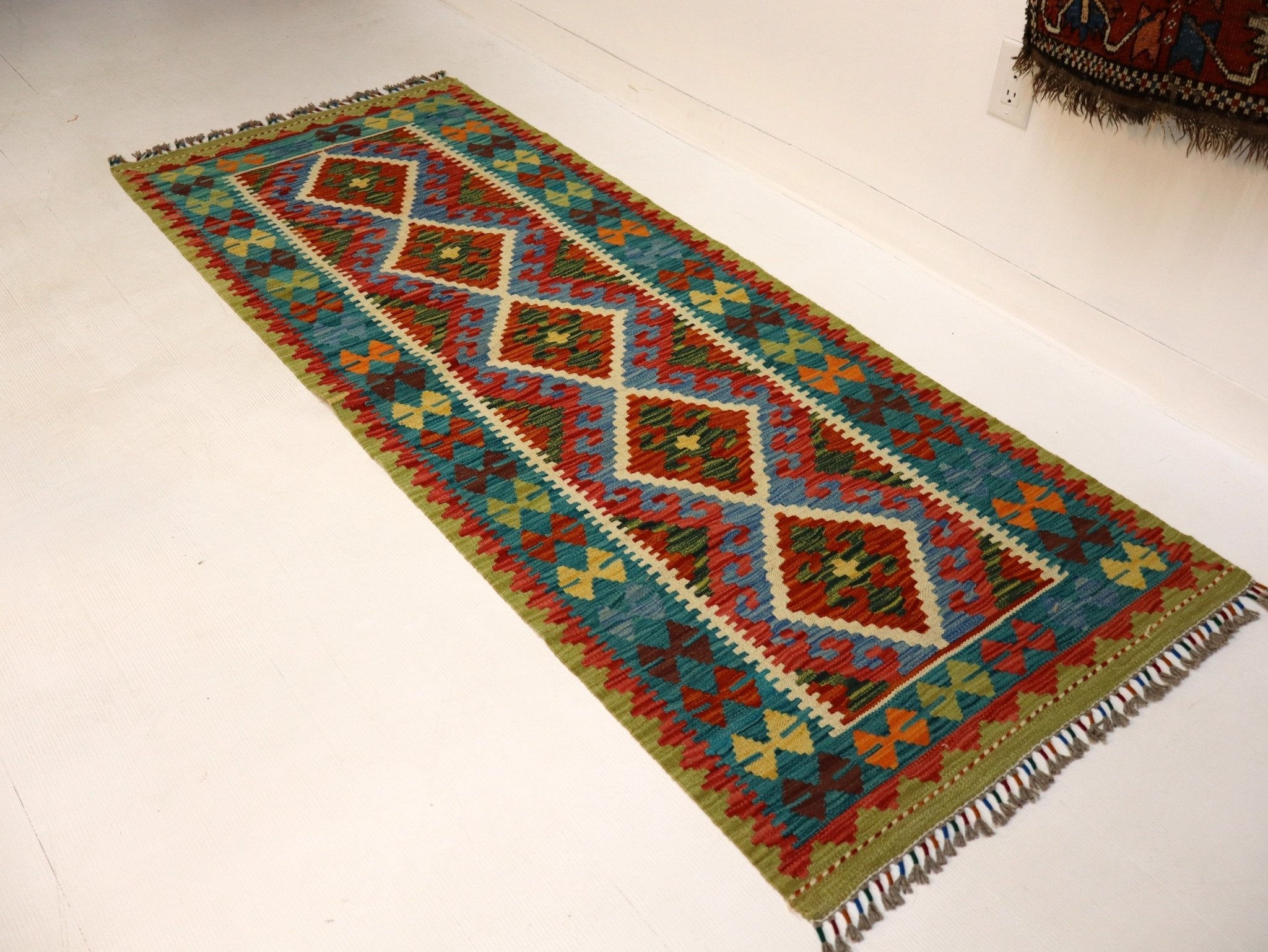 Afghan kilim rug with multicolor diamonds, zigzag bands, and short fringed edges