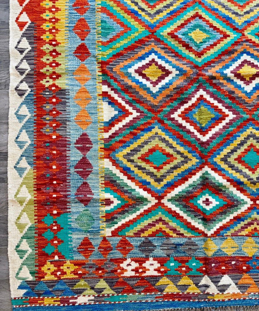 Multicolor kilim rug with diamond and zigzag pattern, short fringe edge