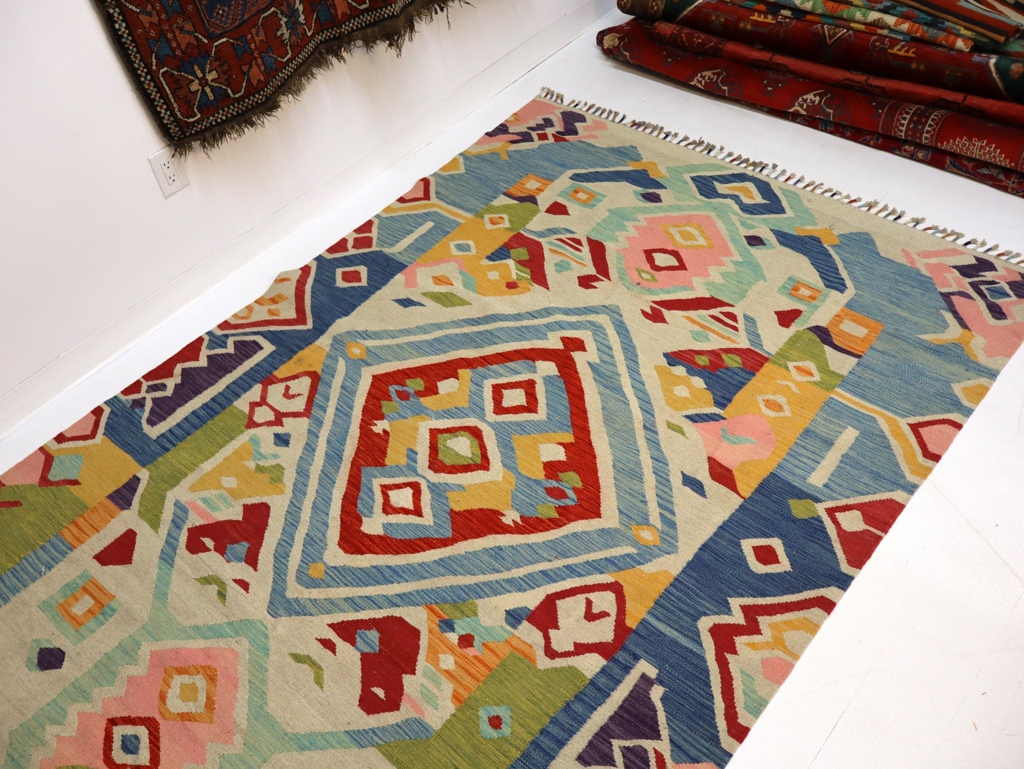Kilim rug with central geometric square medallion and multicolor border patterns