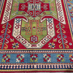 Border and edge detail of red & green Kazak-inspired wool rug 24948.