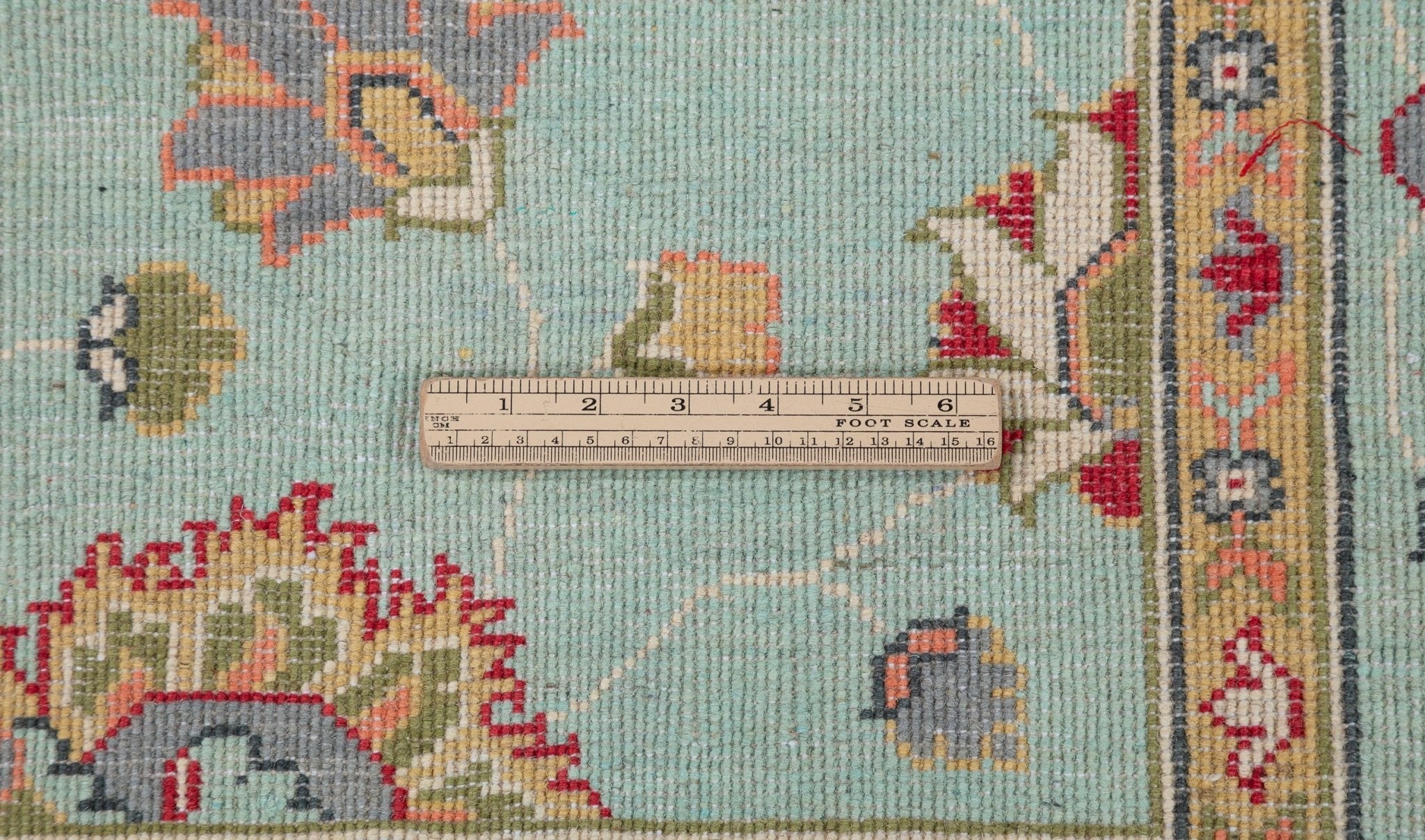 Wool pile close-up of turquoise & red Kazak-inspired wool rug 29664.