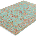 Full view at an angle of turquoise & red Kazak-inspired wool rug 29664.