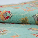 Folded edge and wool pile of turquoise & red Kazak-inspired wool rug 29664.