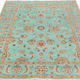 Full view from a low angle of turquoise & red Kazak-inspired wool rug 29664.