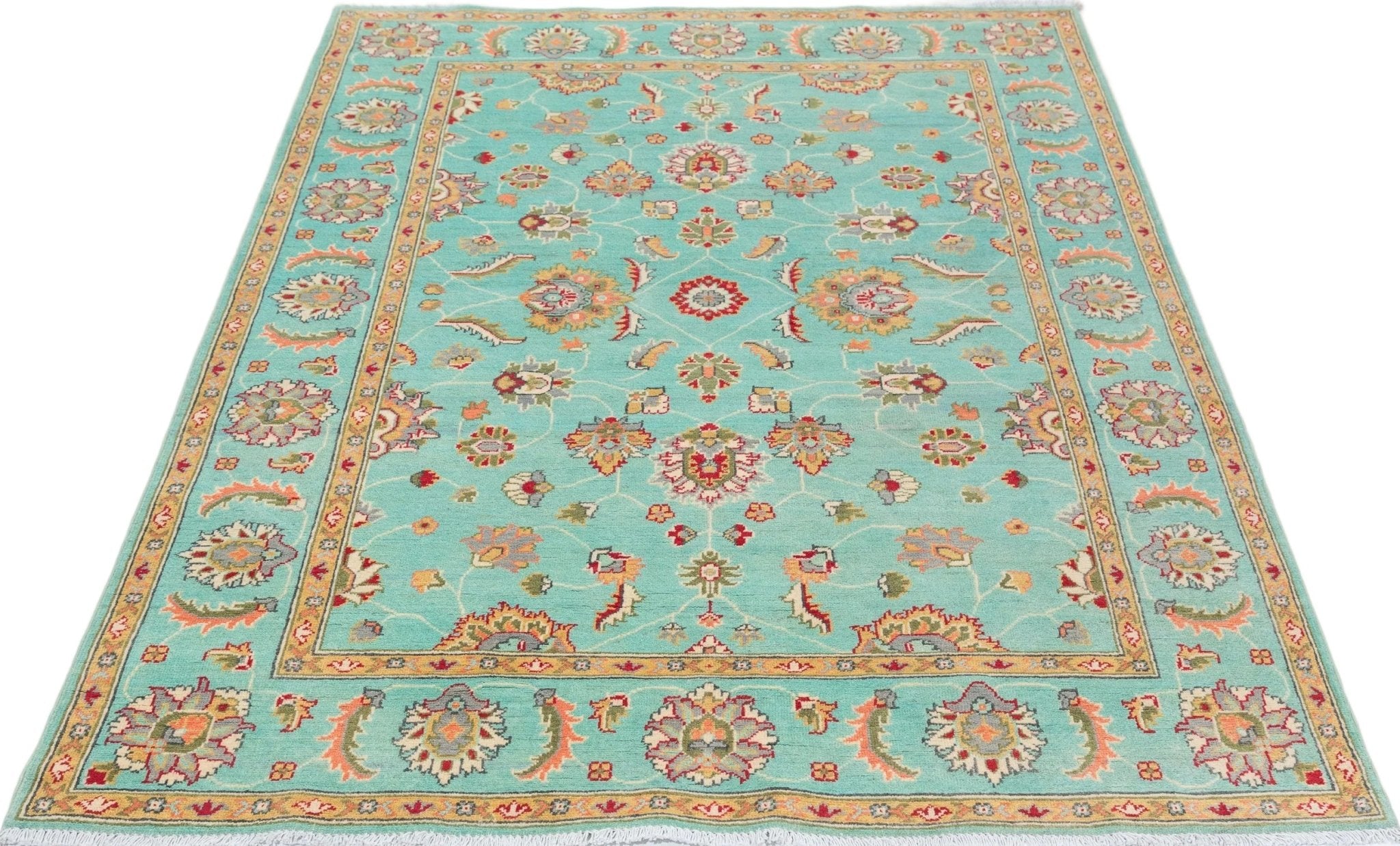 Full view from a low angle of turquoise & red Kazak-inspired wool rug 29664.