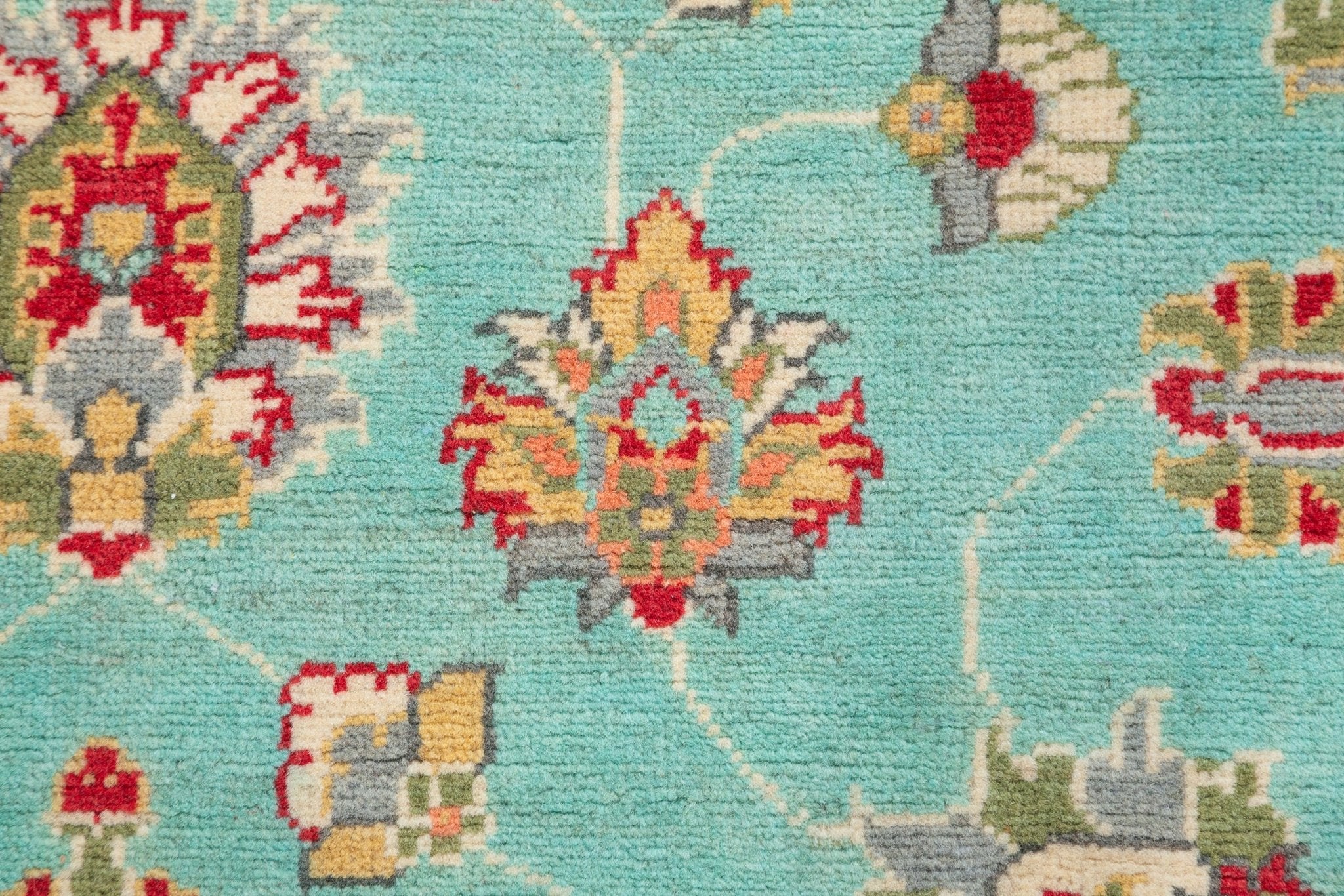 Pattern detail of turquoise & red Kazak-inspired wool rug 29664.