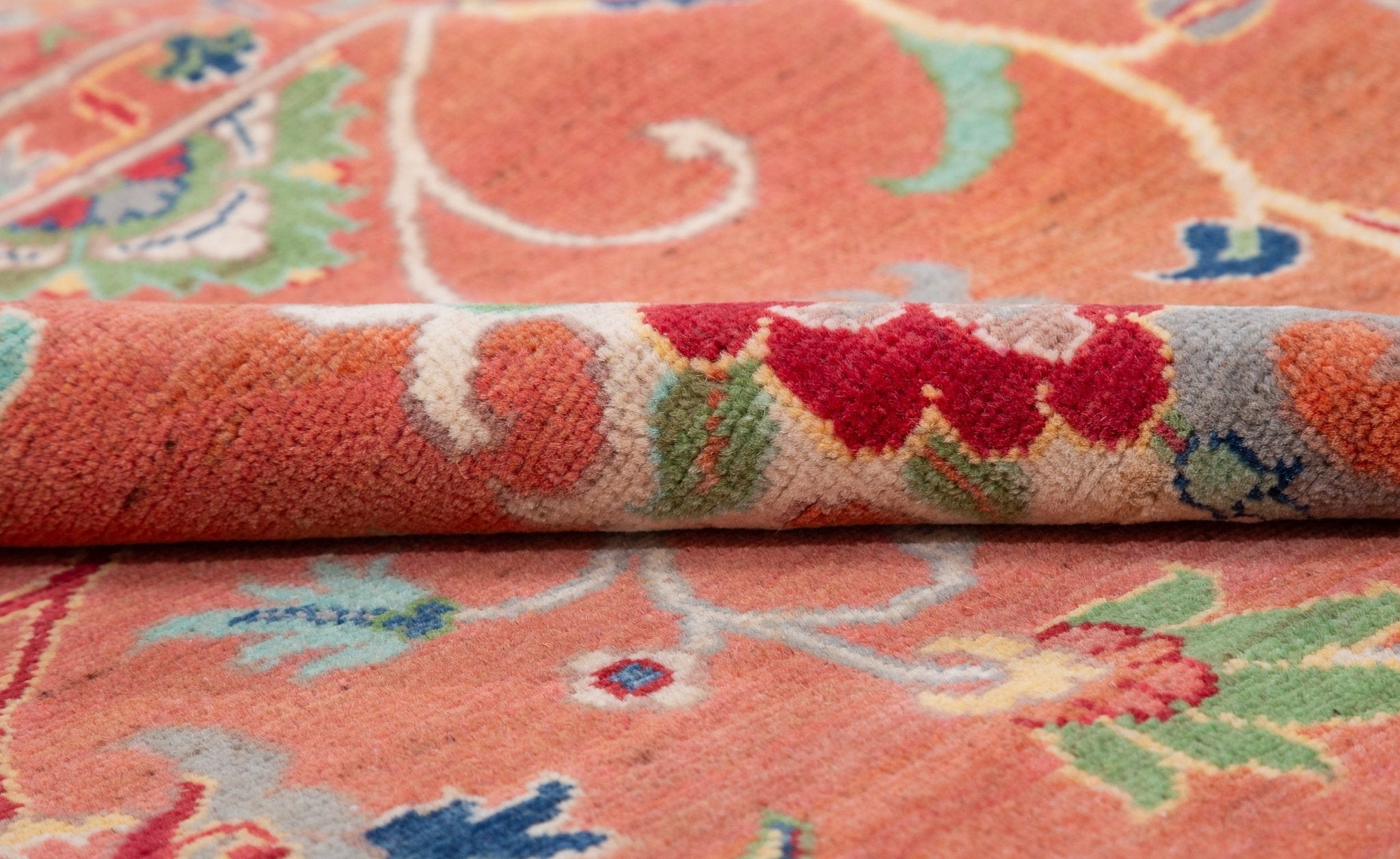 Folded edge and wool pile of orange & blue Kazak-inspired wool rug 29636.