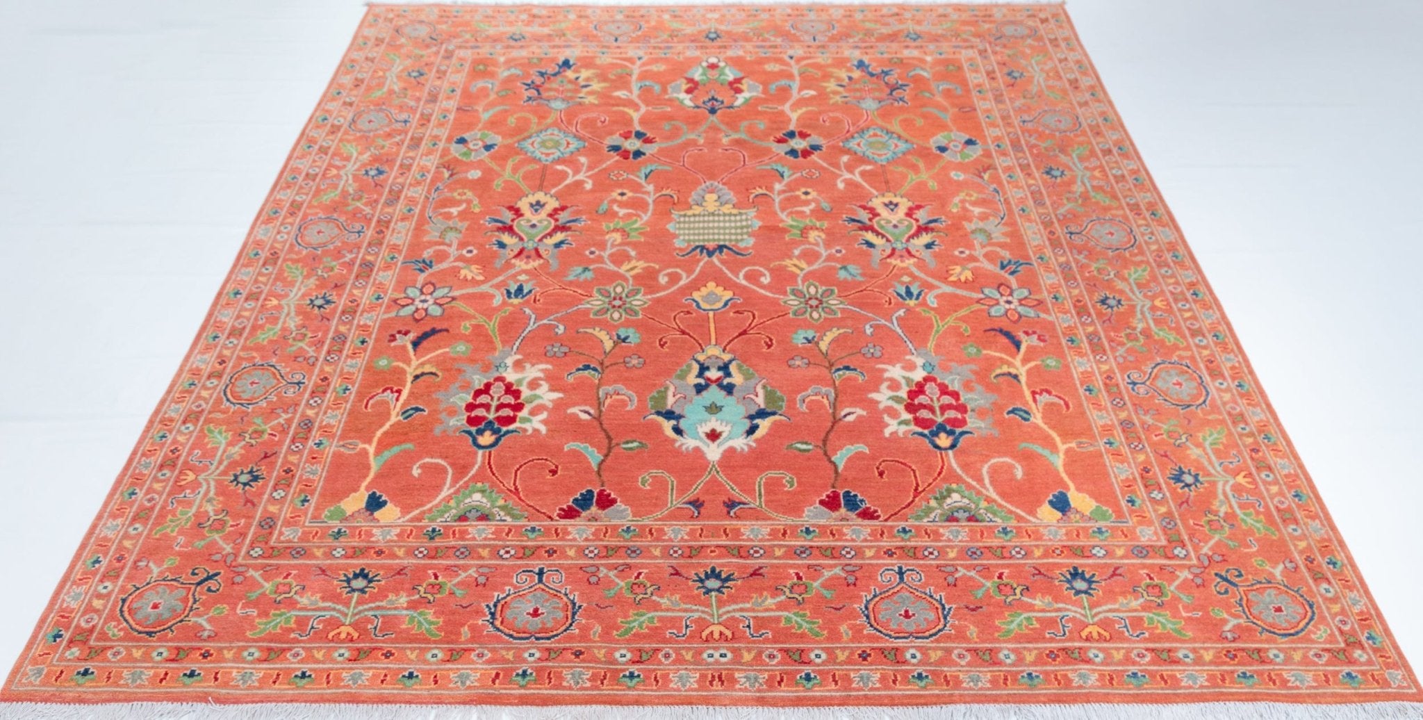 Full view from a low angle of orange & blue Kazak-inspired wool rug 29636.