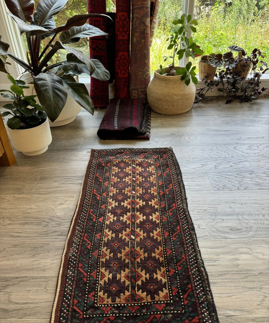 Baluch bag face rug with multicolor diamond pattern and red teal edging