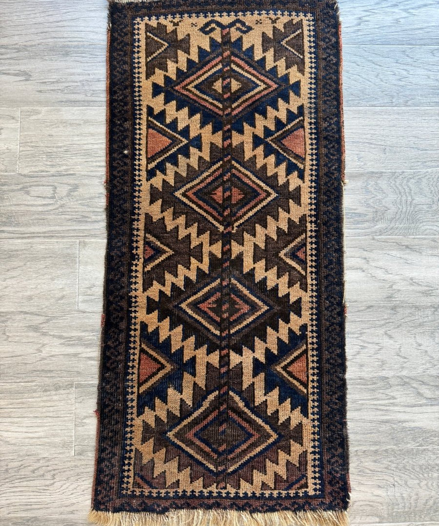 Antique Baluch bag face rug, rectangular design with navy, tan, and red zigzag motifs