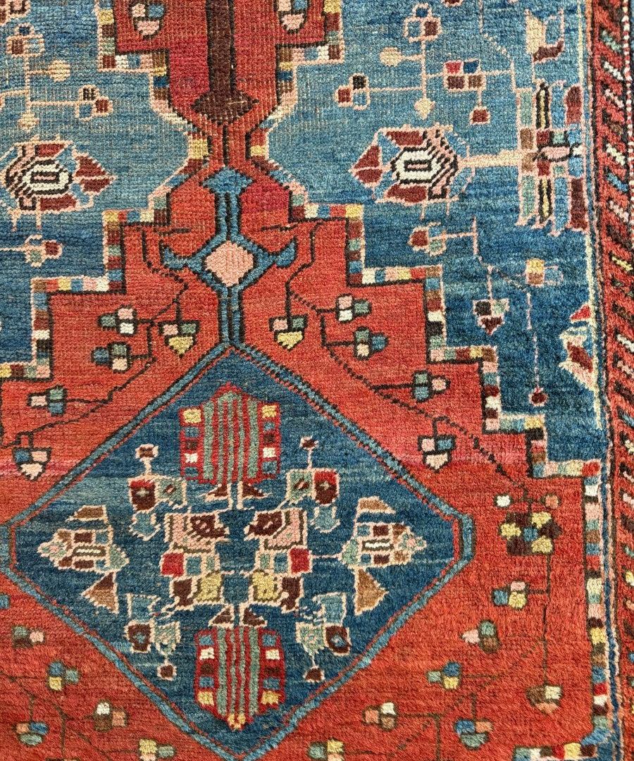 Antique Bidjar runner rug close-up with red, blue, and cream floral motifs