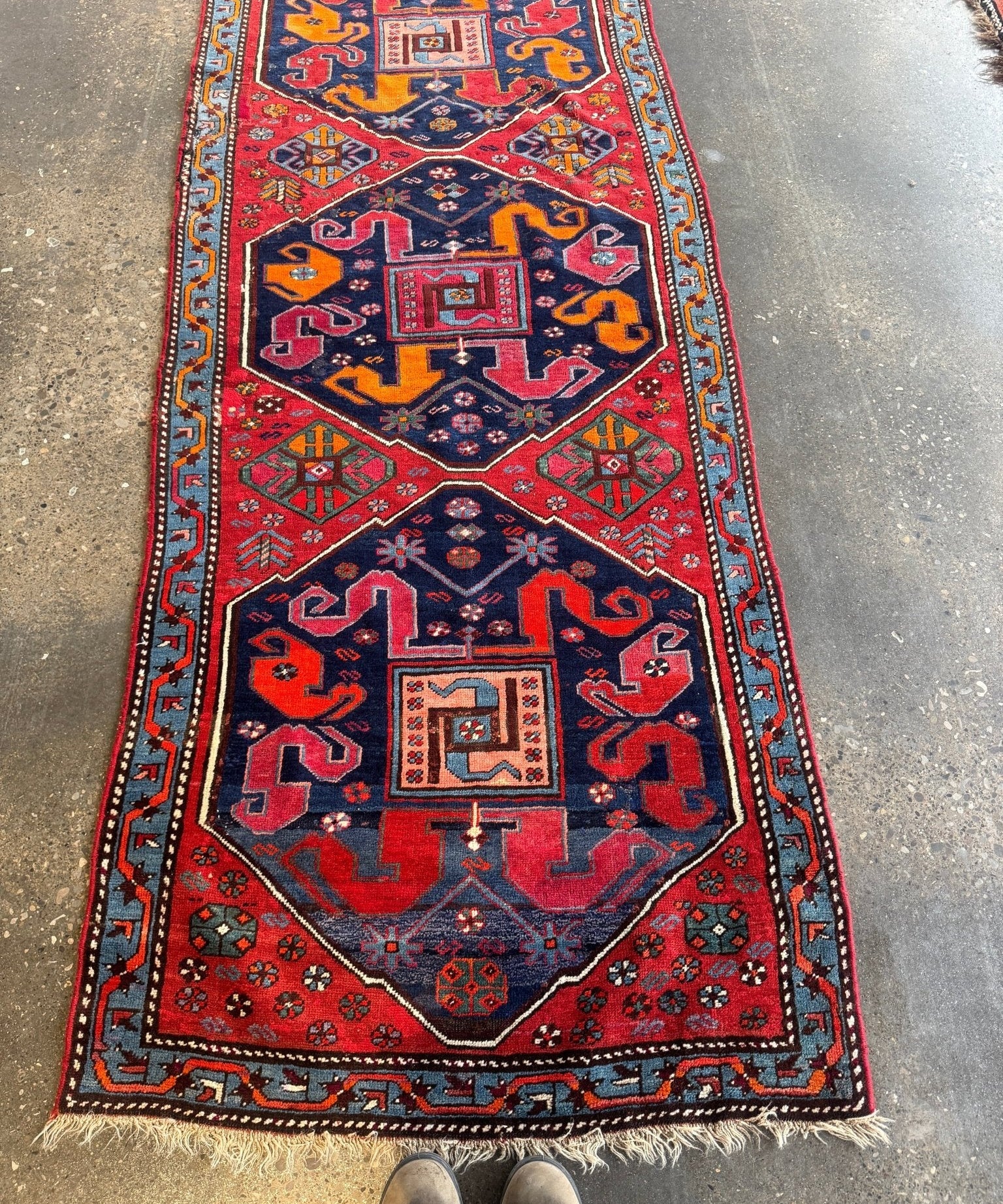 Full Karabagh rug runner with red, navy, and orange medallions and fringed ends.
