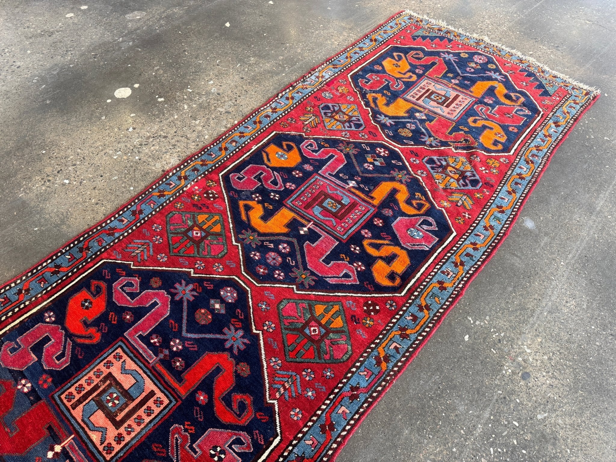 Dark red and navy geometric antique runner with central medallion and border