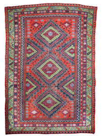Soumak rug with red central medallion, blue geometric zigzags, green side panels and border