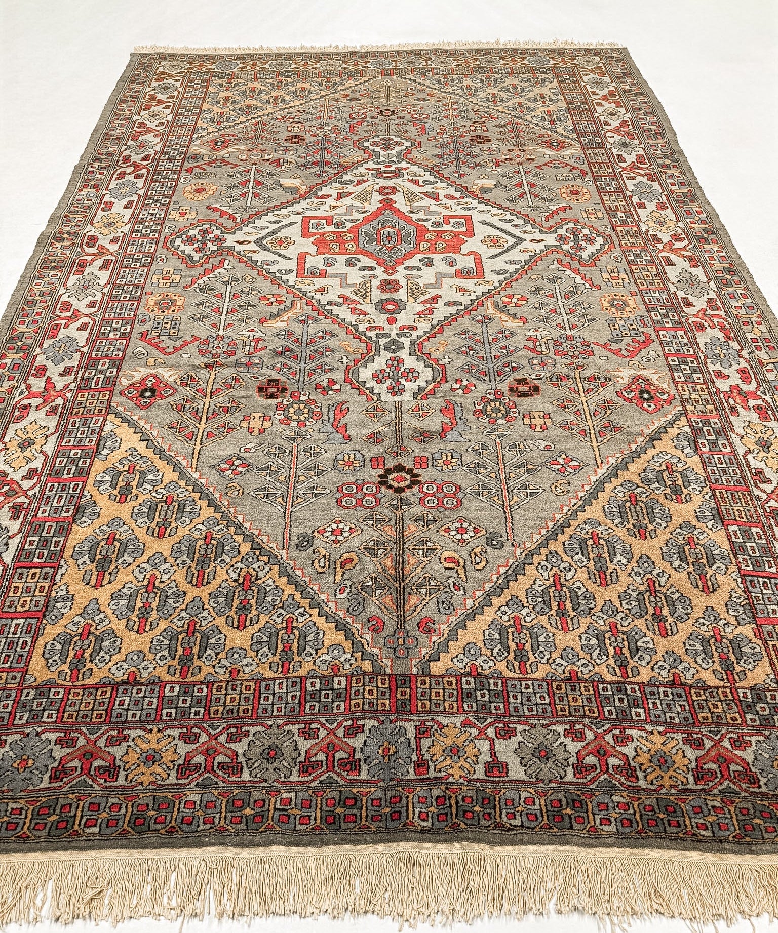 Egyptian oriental rug with red patterned medallion on gray ground and long cream fringe