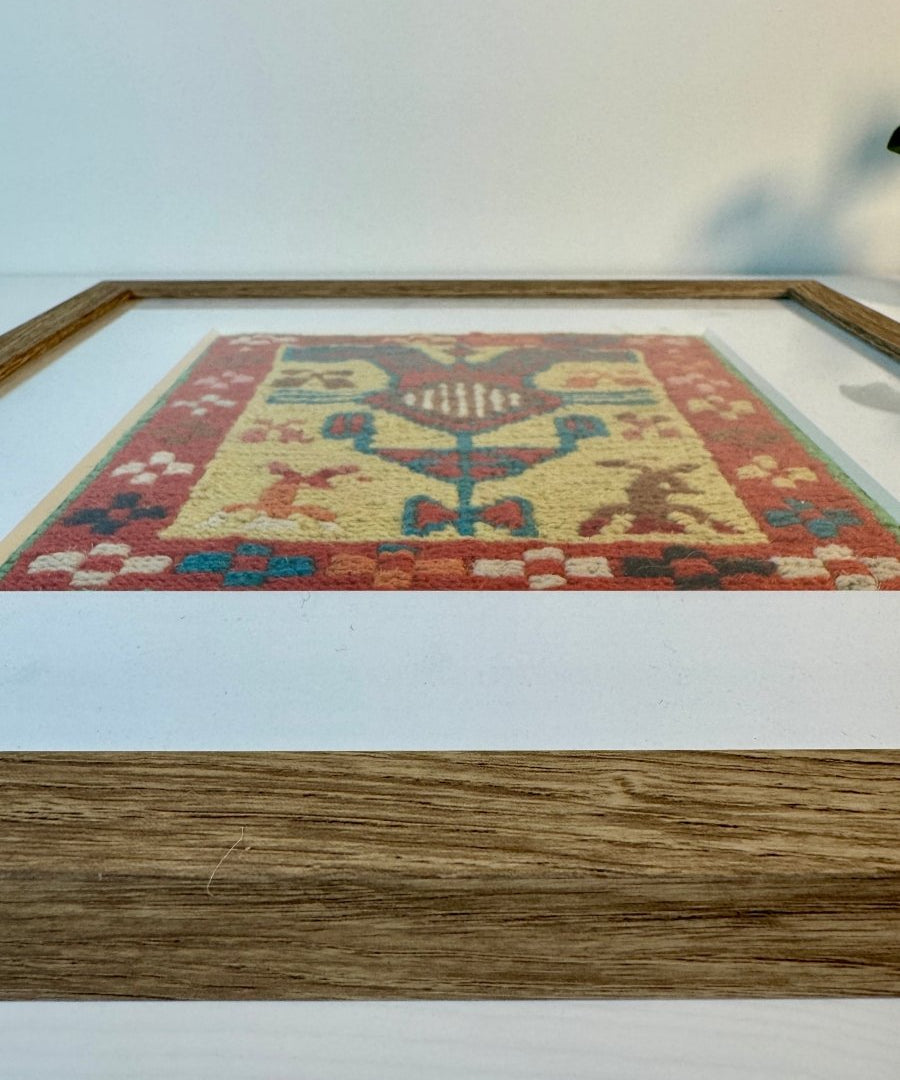 Framed kilim wall art showing wooden frame and beige woven center on white mat.