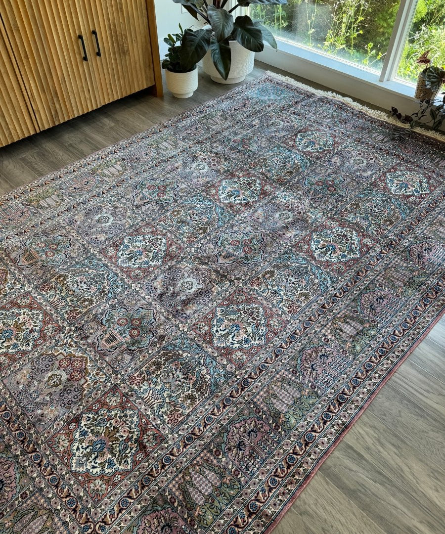 Kashmir-style area rug with teal, blue, and rust floral medallion pattern and border.