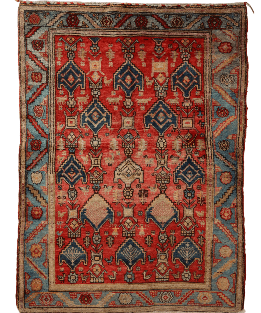 Red rug with symmetrical geometric diamond medallions, dark blue and beige border