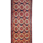 Persian runner rug with navy and red medallion pattern on cream ground