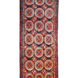 Persian runner rug with navy and red medallion pattern on cream ground