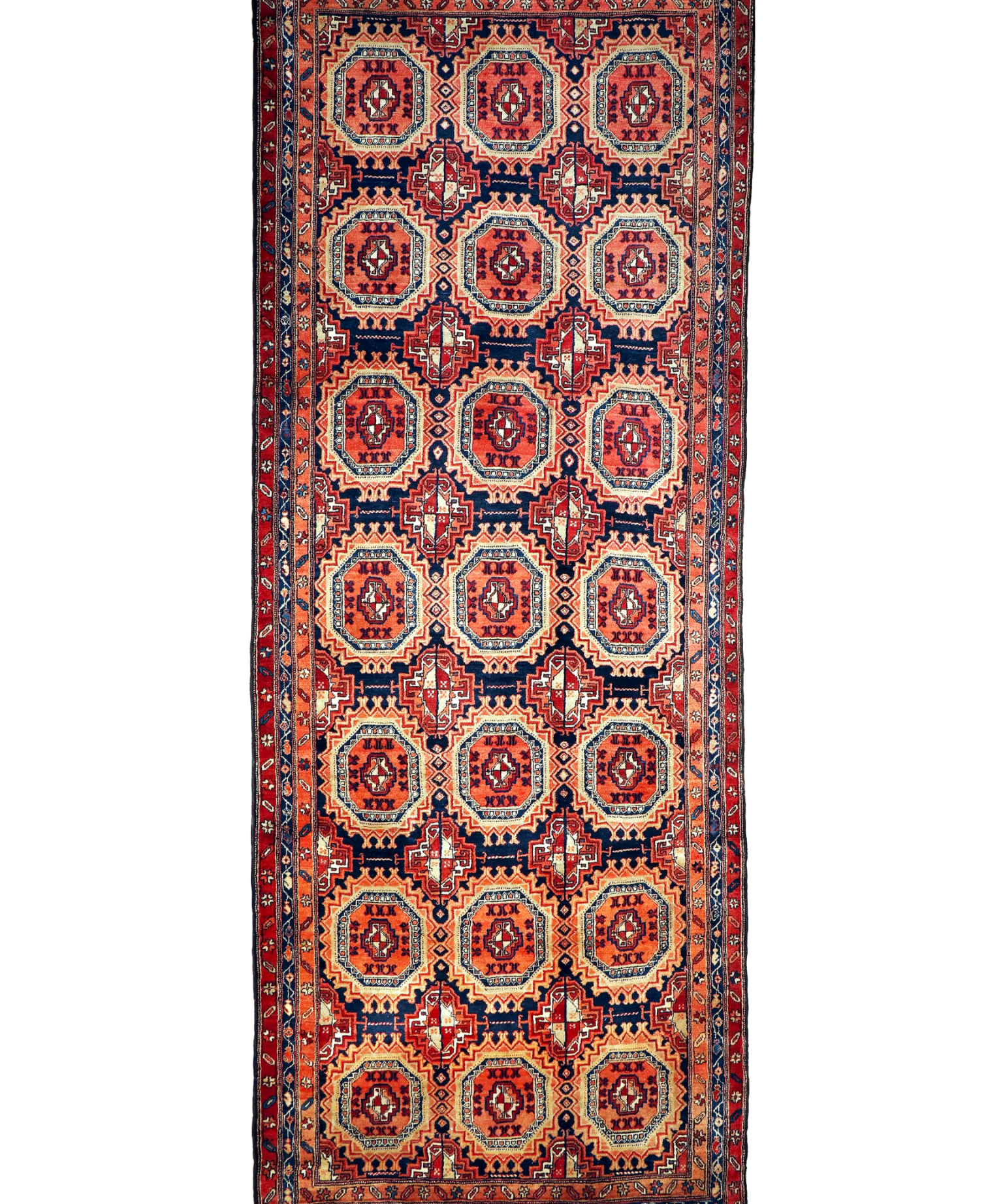 Persian runner rug with navy and red medallion pattern on cream ground