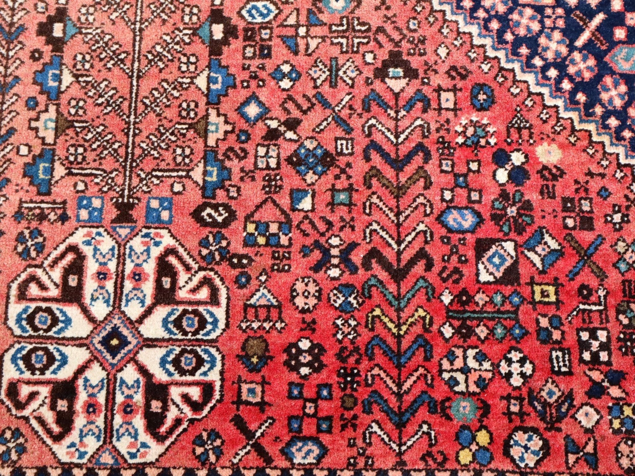 Persian Abadeh rug pattern cluster with teal and cream highlights on red background