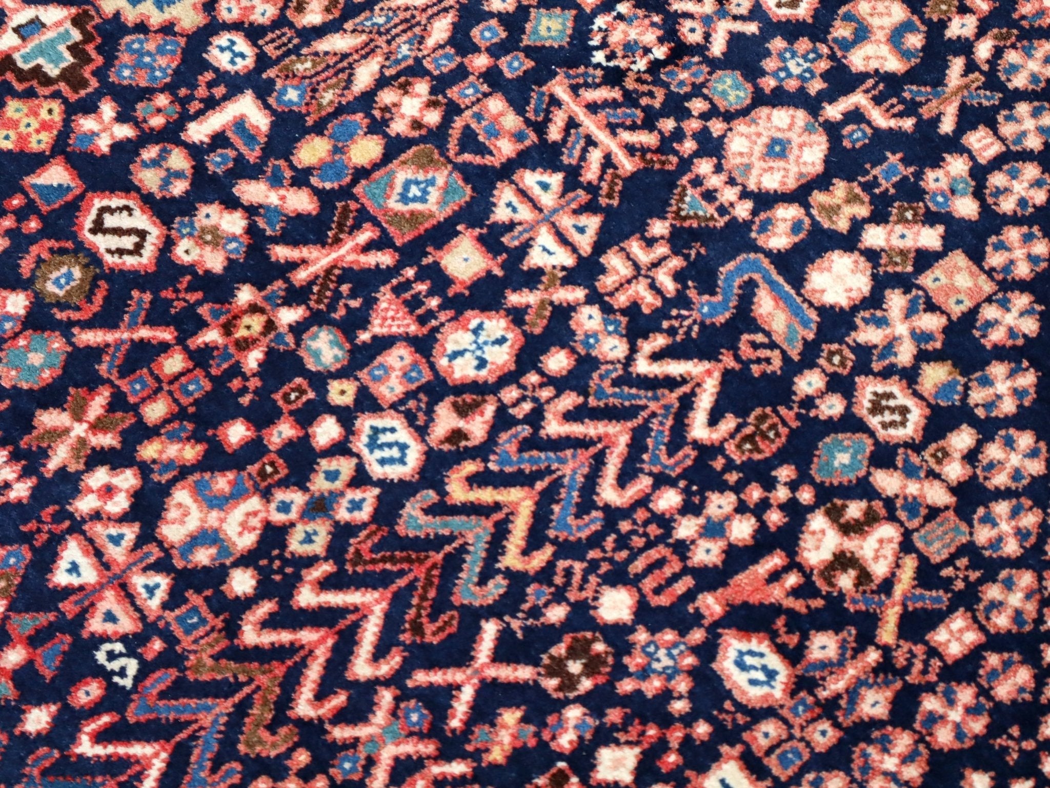 Persian Abadeh rug detailed navy pattern with small red, cream, and teal shapes