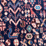 Navy patterned rug with zigzag chevrons, octagon medallion, and multicolor accents