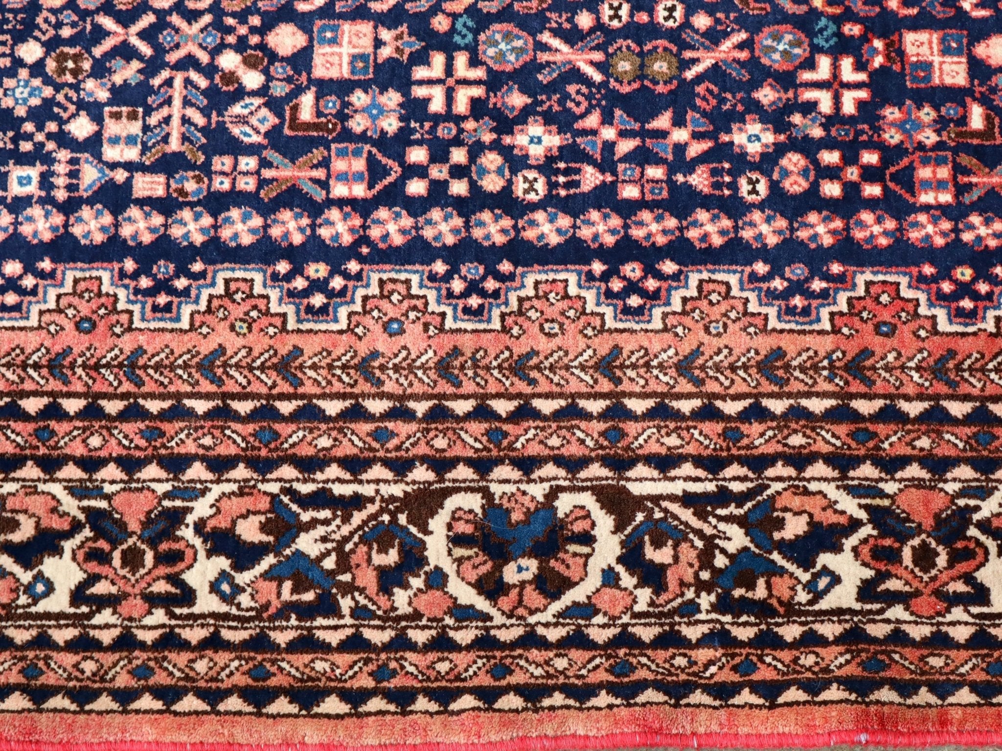 Persian Abadeh rug border with repeating zigzags and floral accents in navy