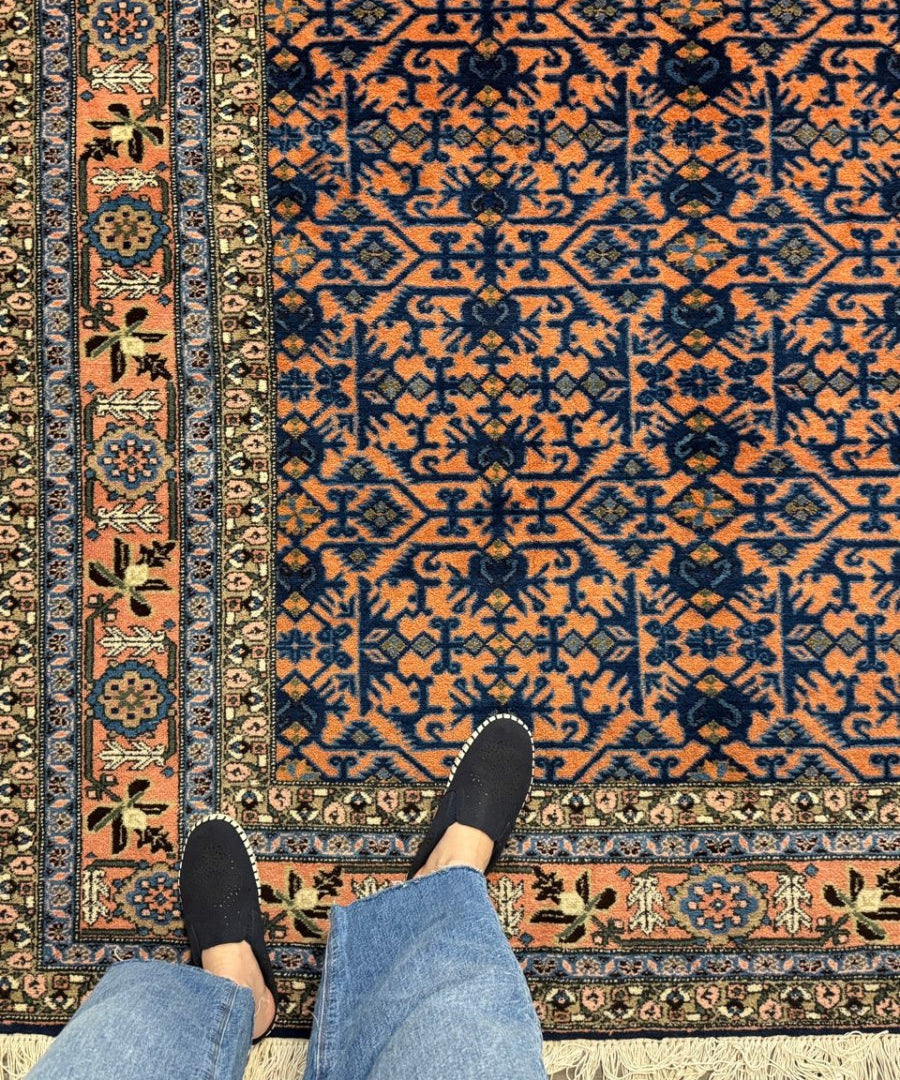 Persian Ardabil rug with blue and orange geometric pattern, cream border, fringe