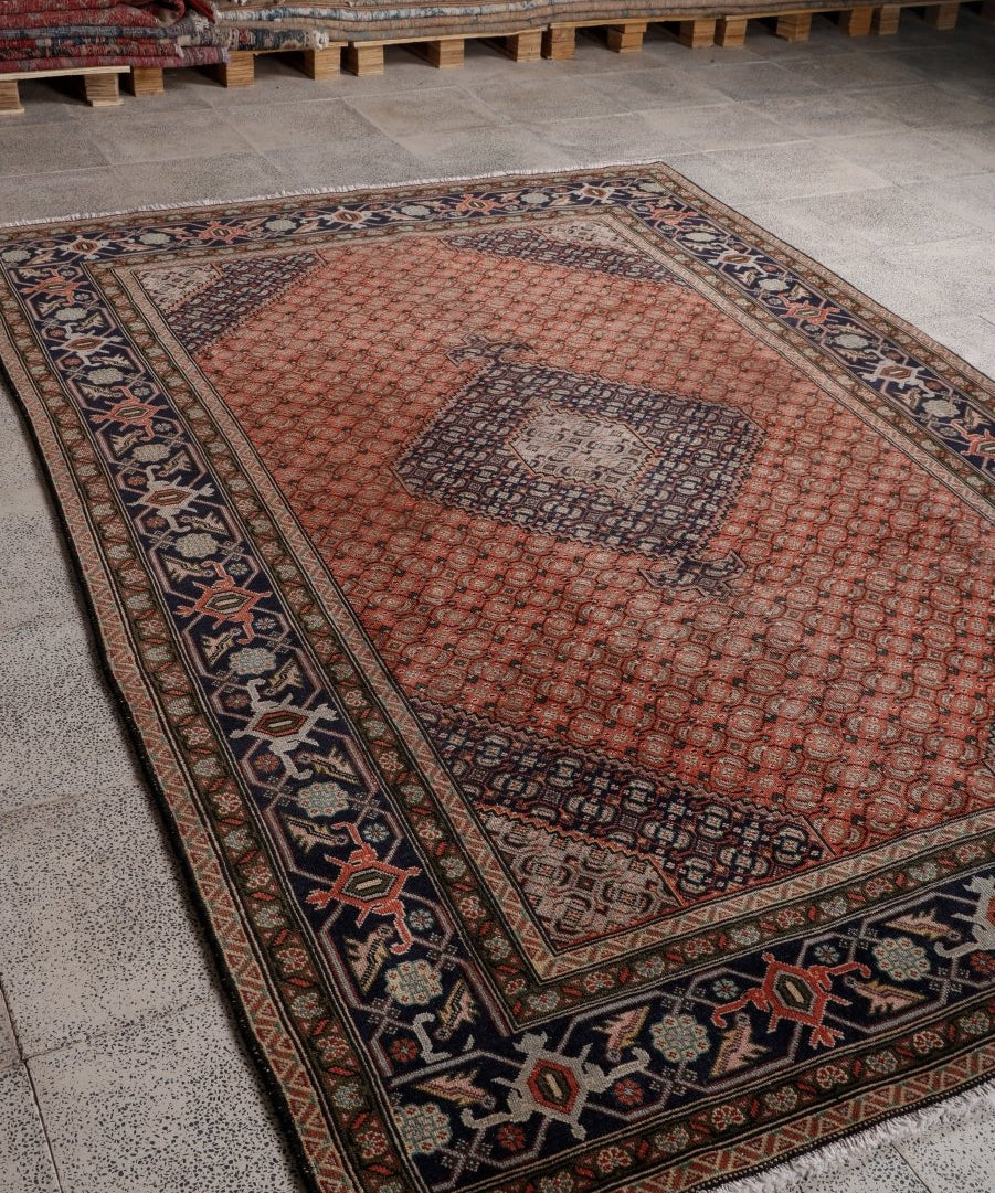 Persian Ardabil-style rug with rust center medallion and dark navy border