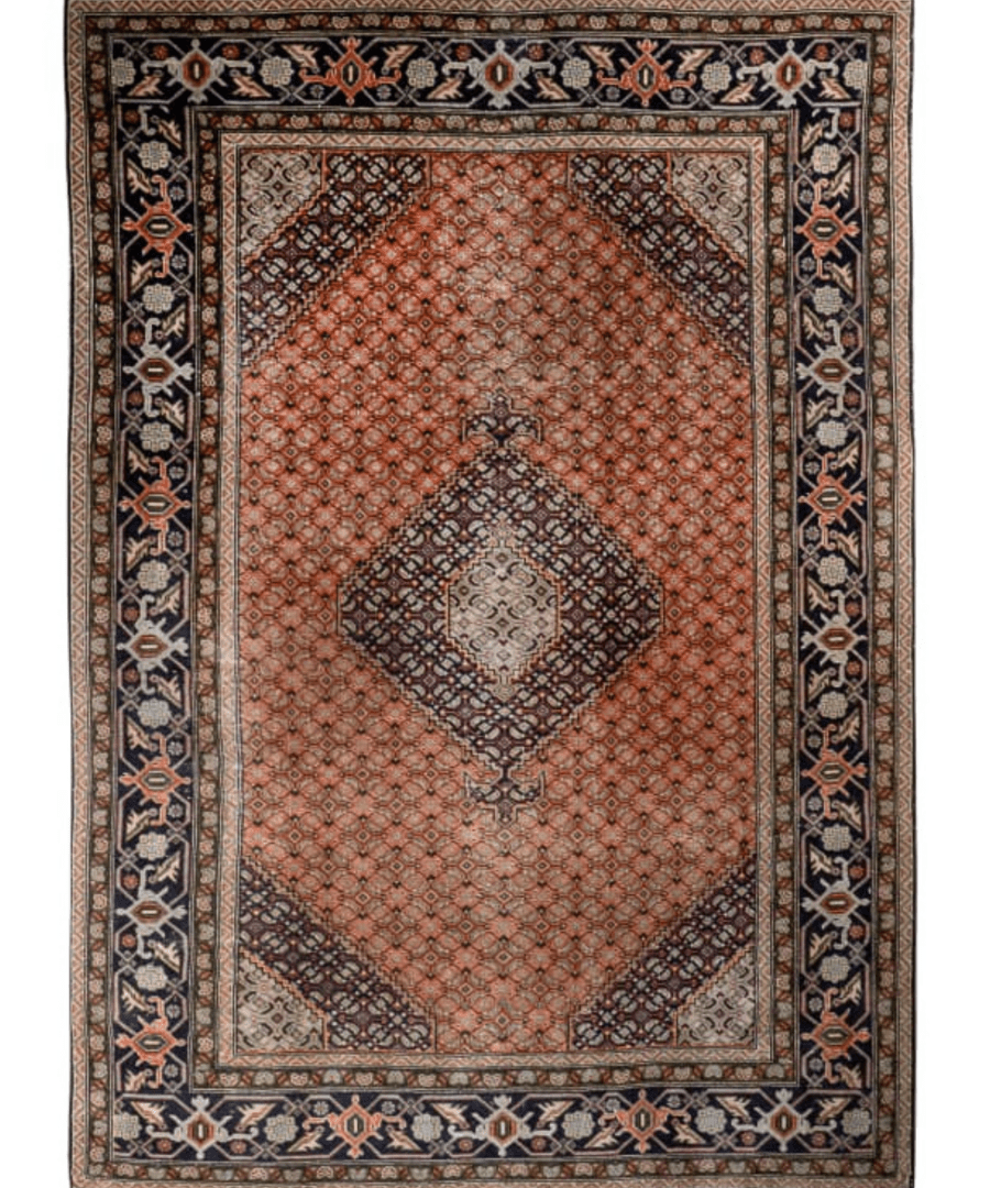 Persian Ardabil-style rug, centered rust medallion with navy border and light guard stripes