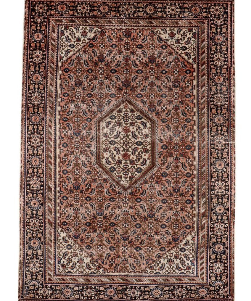 Persian-style rug with terracotta red field, dark navy border, and cream diamond medallion