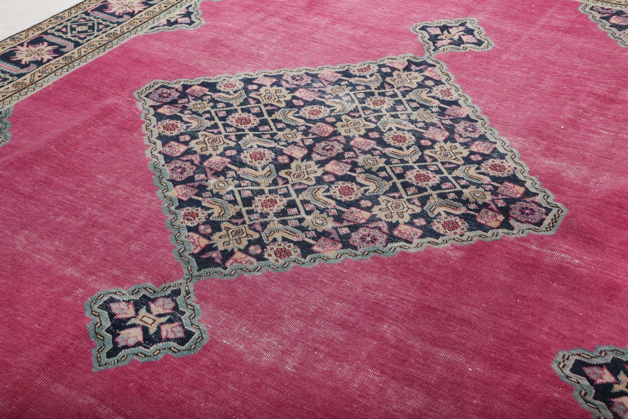 Persian Ardabil rug in pink with central navy floral medallion